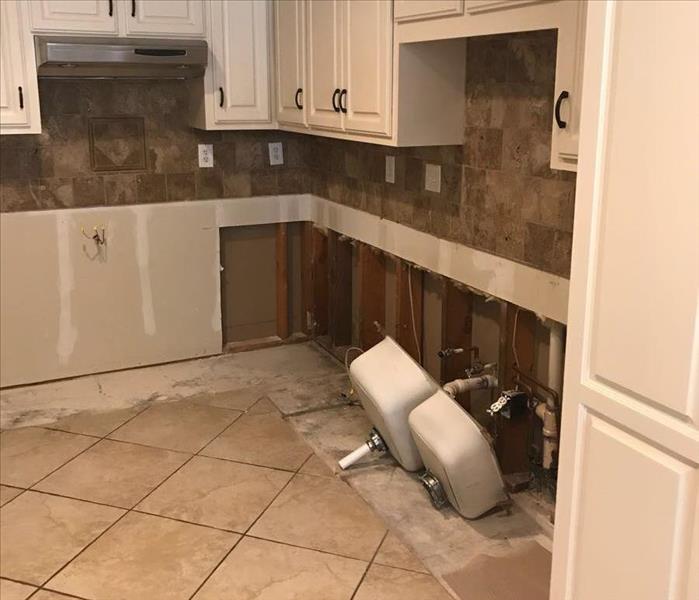 kitchen with cabinets removed, wet flooring